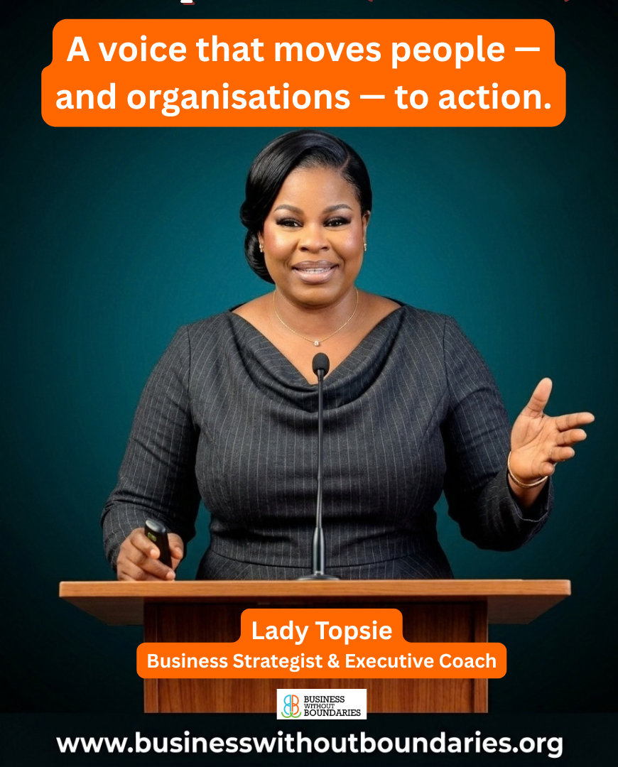 Olutope Olatilewa E. (Lady Topsie) speaking on stage with a microphone